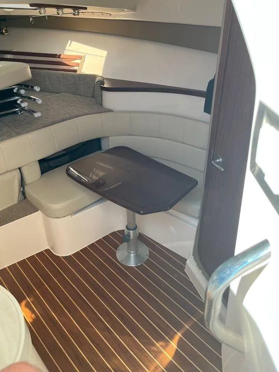 Slide: The Image of Interior seating area of 2020 Grady-White 330 Express boat with wooden table. - 21