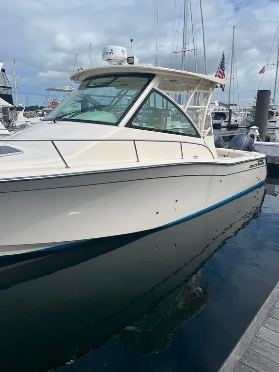 Slide: The Image of 2020 Grady-White 330 Express boat docked at a marina. - 3