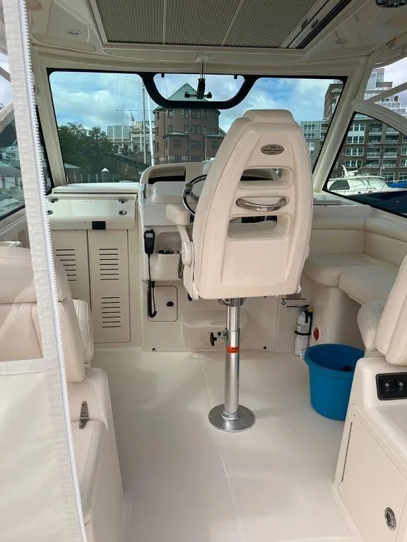 Slide: The Image of 2020 Grady-White 330 Express boat interior with captain's chair and control panel. - 7