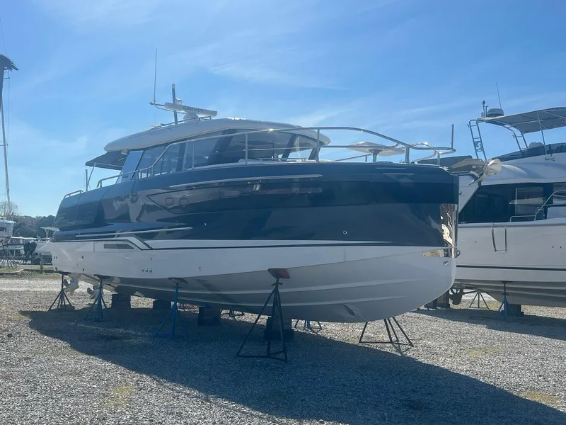 Slide: The Image of 2025 Wellcraft 44 Explorer boat on display in a marina under clear blue skies. - 1
