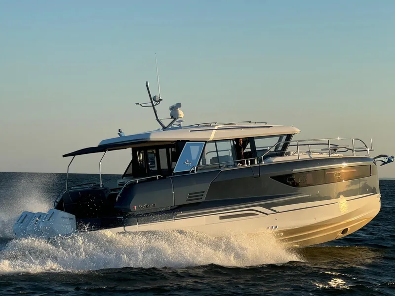 Slide: The Image of 2025 Wellcraft 44 Explorer yacht cruising on open water at sunset. - 3