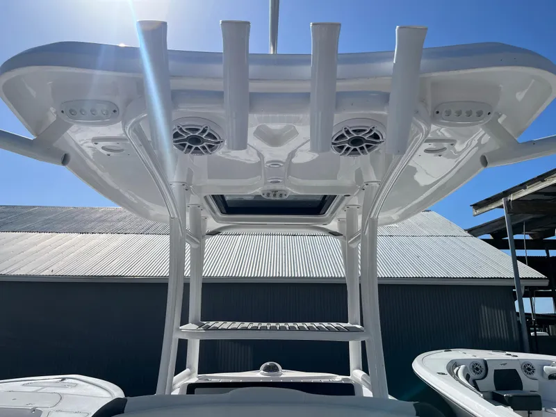 Slide: The Image of 2025 Tidewater 2500 Carolina Bay boat with T-top and rod holders. - 11