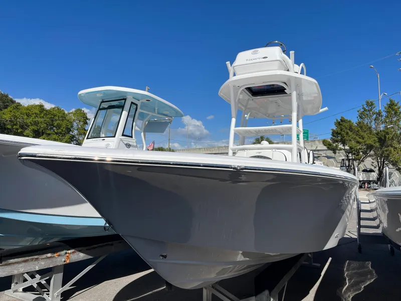 Slide: The Image of 2025 Tidewater 2500 Carolina Bay boat displayed outdoors under clear blue sky. - 2