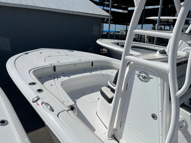 Slide: The Image of 2025 Tidewater 2500 Carolina Bay boat, white interior, docked in a marina. - 6