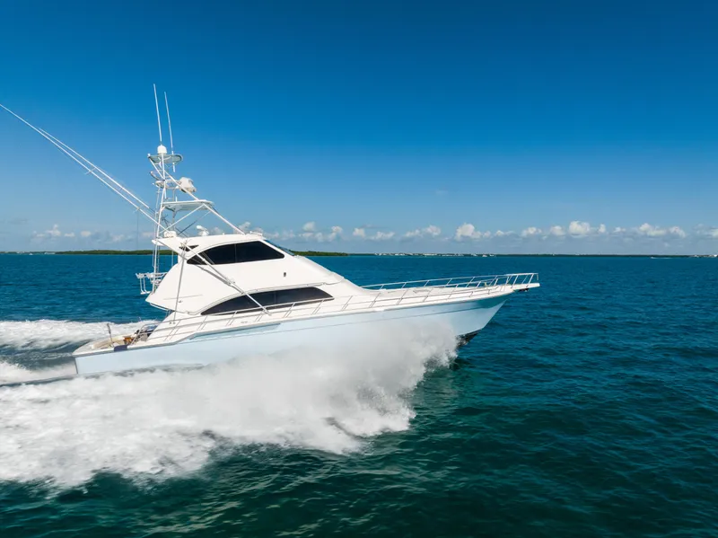 Slide: The Image of 2009 Bertram 630 yacht cruising on open blue ocean. - 1