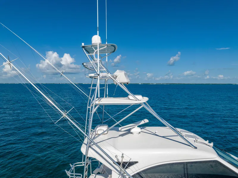 Slide: The Image of Bertram 630 yacht (2009) with tower against a clear blue ocean and sky. - 11