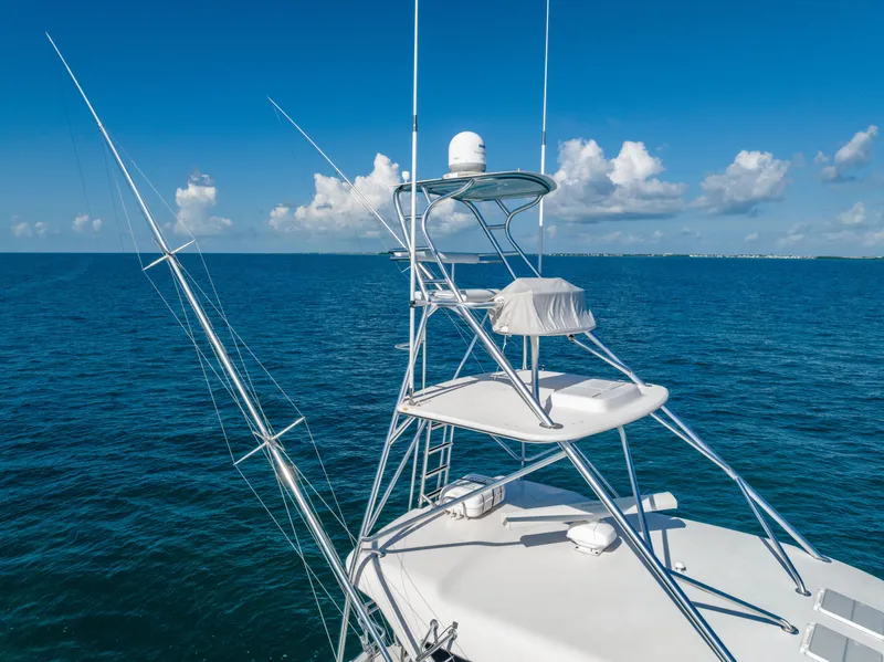 Slide: The Image of Bertram 630 yacht tower, 2009 model, cruising on clear blue ocean under a bright sky. - 12