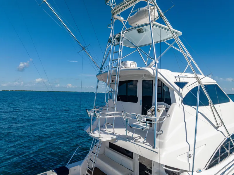 Slide: The Image of 2009 Bertram 630 yacht on open blue sea under clear sky. - 13