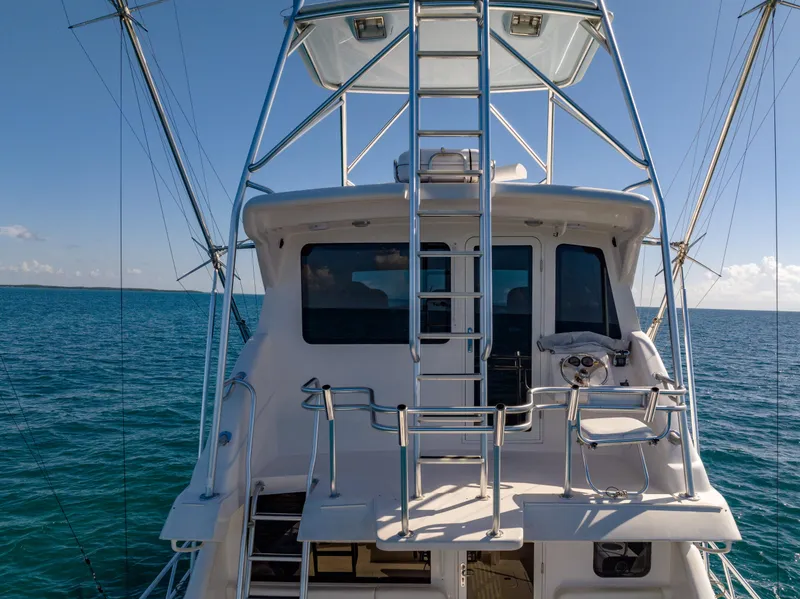Slide: The Image of Bertram 630 yacht, 2009 model, on open sea with clear blue sky. - 14
