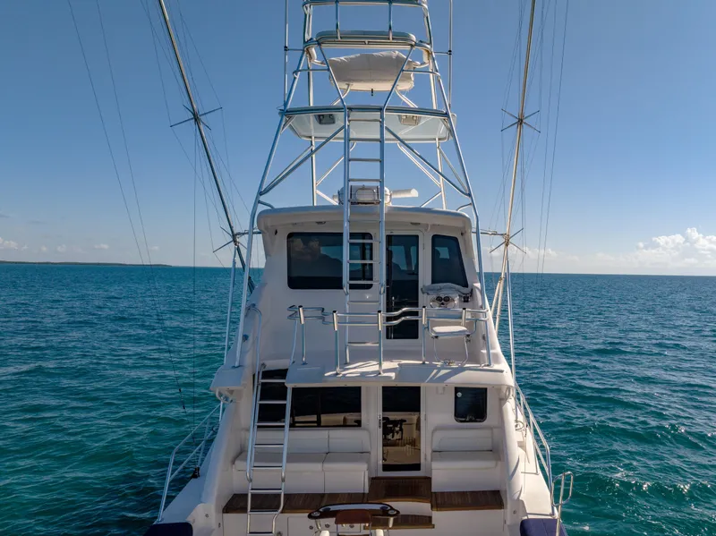 Slide: The Image of Bertram 630 yacht, 2009 model, cruising on open sea with clear blue sky. - 15