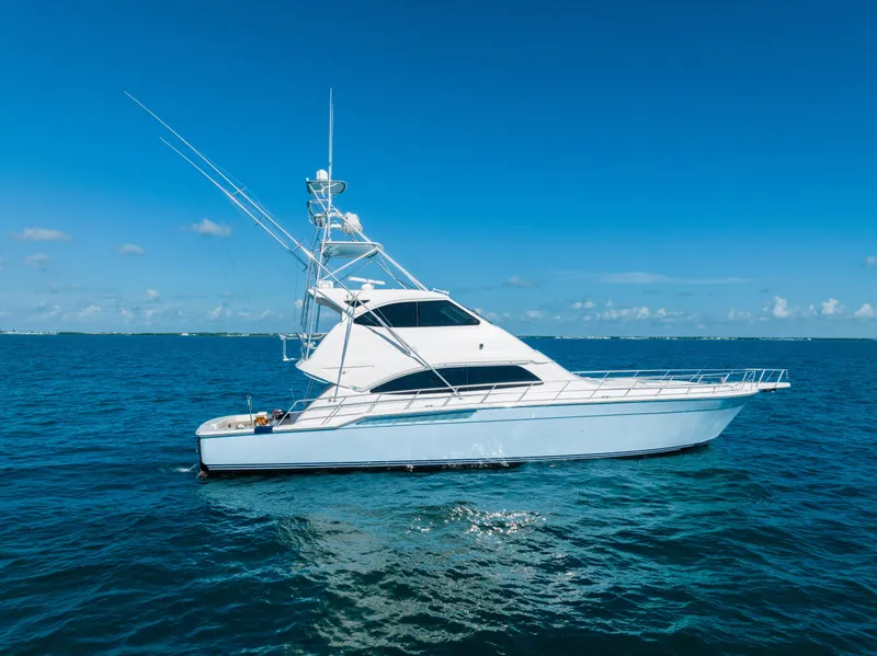 Slide: The Image of 2009 Bertram 630 yacht cruising on open blue sea under clear sky. - 18