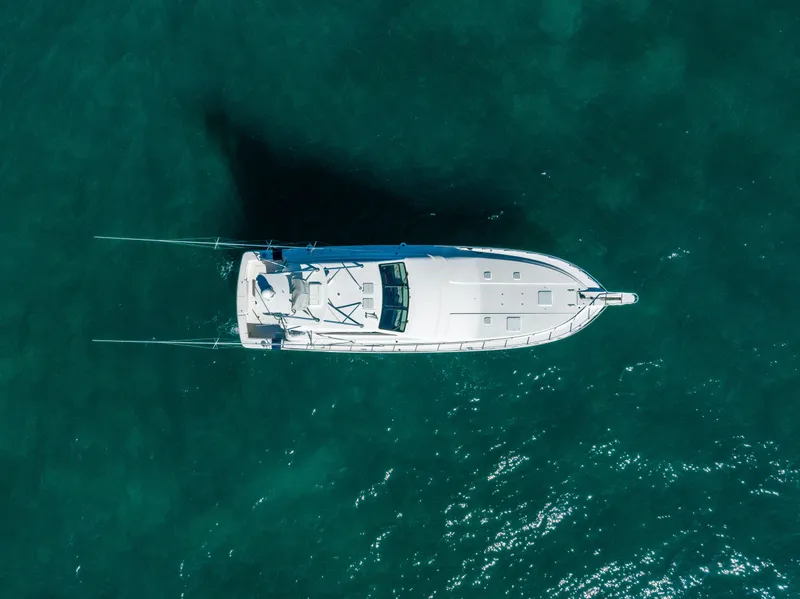 Slide: The Image of Aerial view of a 2009 Bertram 630 yacht on clear blue water. - 19
