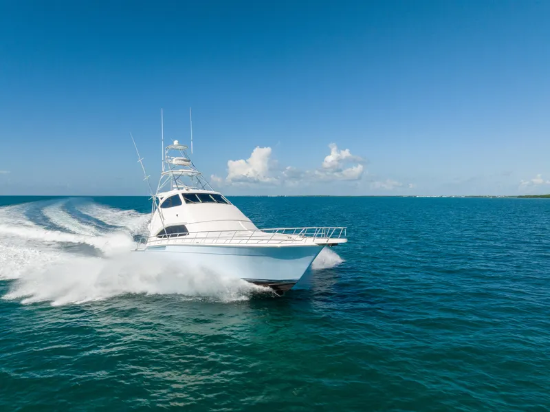 Slide: The Image of 2009 Bertram 630 yacht cruising on open blue ocean. - 2