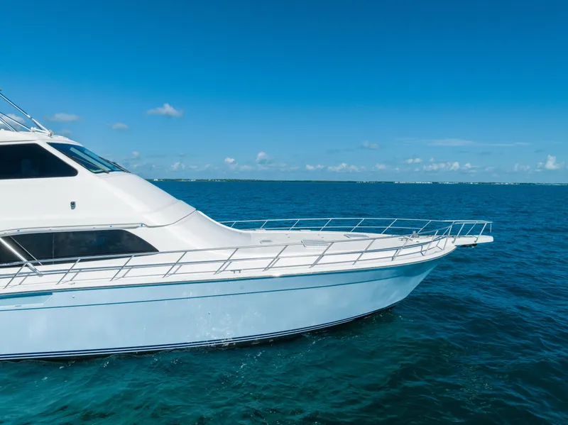 Slide: The Image of 2009 Bertram 630 yacht cruising on clear blue ocean waters. - 20