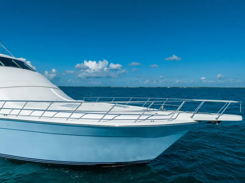 Slide: The Image of 2009 Bertram 630 yacht cruising on open blue sea under clear sky. - 21