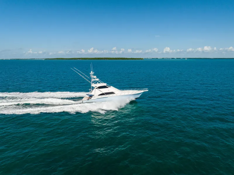 Slide: The Image of 2009 Bertram 630 yacht cruising on open blue ocean. - 26