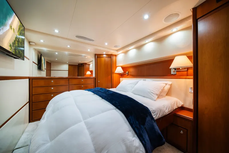 Slide: The Image of Luxurious bedroom interior of 2009 Bertram 630 yacht with wooden cabinetry and cozy bedding. - 35