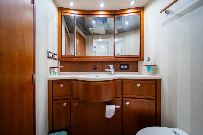 Slide: The Image of Luxurious bathroom in a 2009 Bertram 630 yacht with wooden cabinetry and modern fixtures. - 38