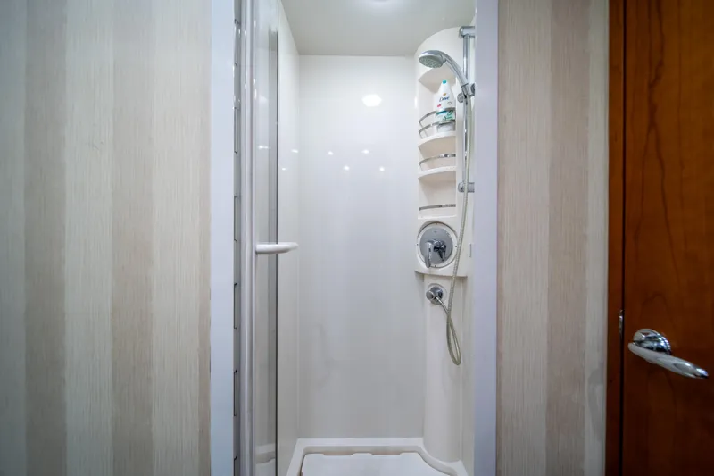 Slide: The Image of Compact shower area in a 2009 Bertram 630 yacht with modern fixtures. - 39