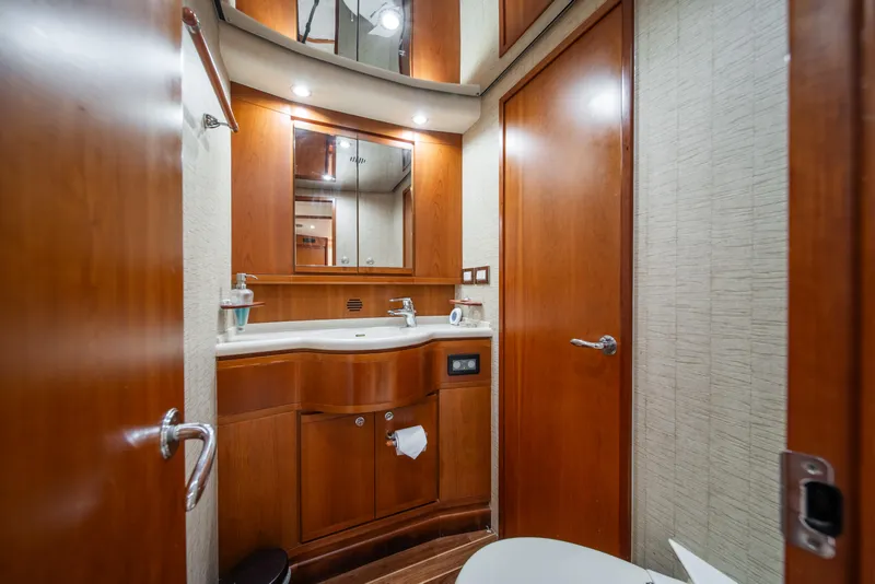 Slide: The Image of Luxurious bathroom in a 2009 Bertram 630 yacht with wooden cabinetry and modern fixtures. - 40