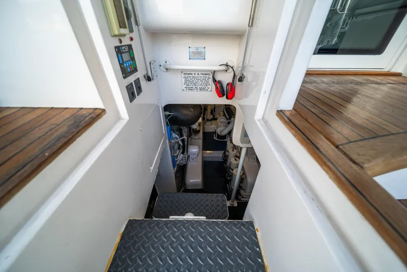 Slide: The Image of Engine room entrance of a 2009 Bertram 630 yacht with control panels and safety equipment. - 42