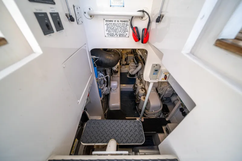 Slide: The Image of Engine room of a 2009 Bertram 630 yacht with visible machinery and safety equipment. - 43