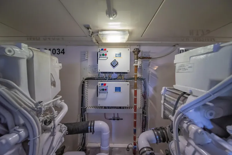 Slide: The Image of Engine room of a 2009 Bertram 630 yacht with control panels and machinery. - 46