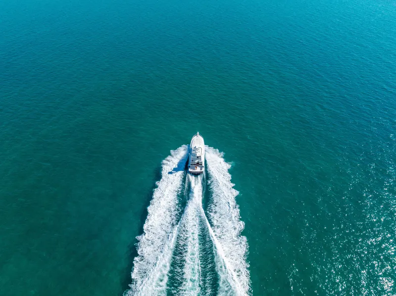 Slide: The Image of Aerial view of a 2009 Bertram 630 yacht cruising on clear blue waters. - 6