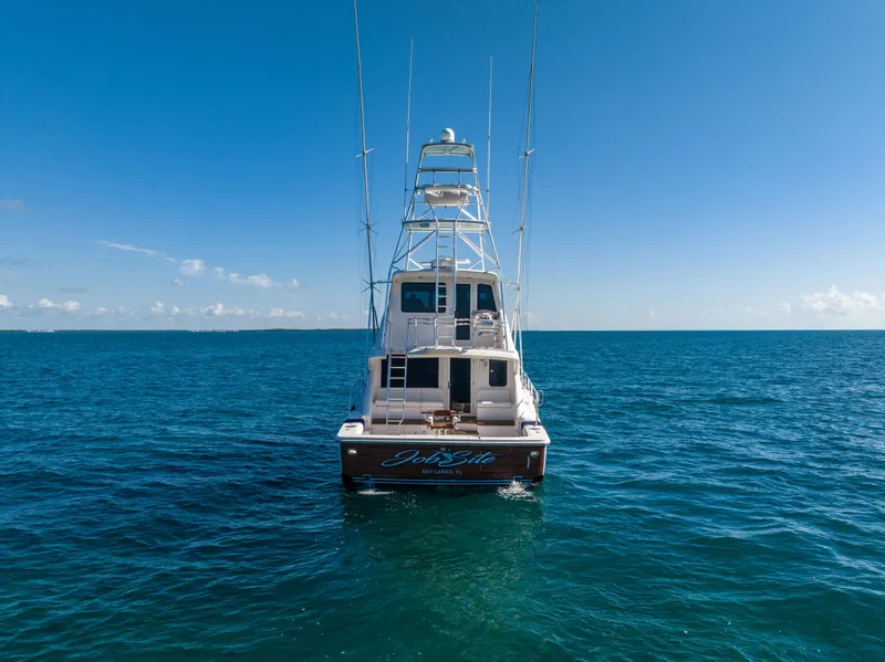 Slide: The Image of Bertram 630 yacht (2009) on open sea, rear view, clear blue sky. - 8