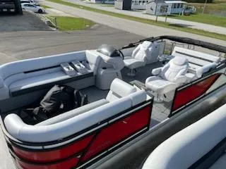 The Image of 2024 Sweetwater 2286SFL pontoon boat with white seating and red exterior. - 0