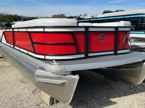 Slide: The Image of 2024 Sweetwater 2286SFL pontoon boat with red exterior on gravel lot. - 3