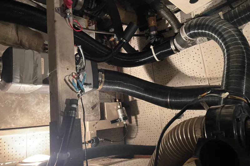 Slide: The Image of Engine room of a 1984 CHB 35 boat with various hoses and wiring. - 10