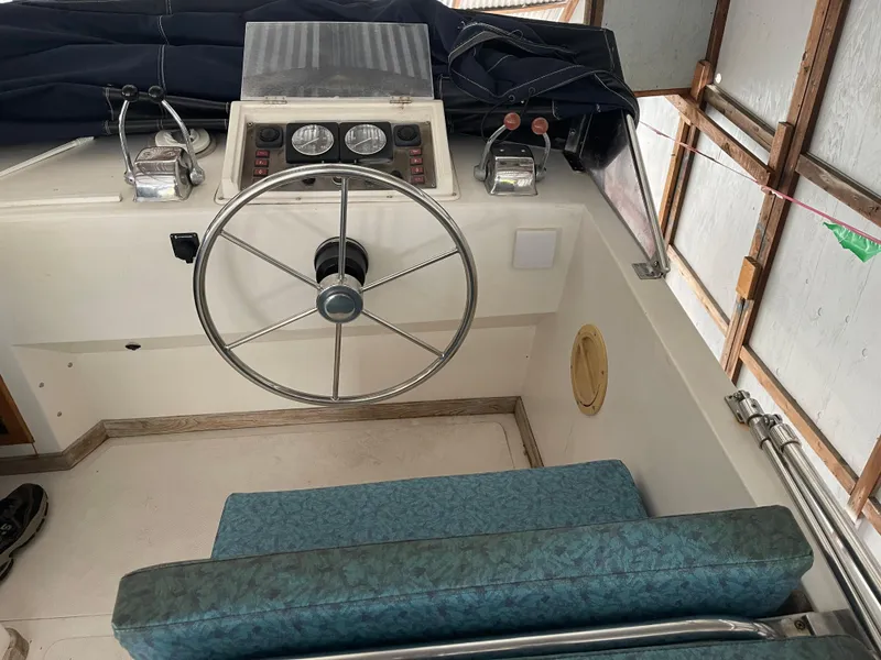 Slide: The Image of 1984 CHB 35 boat helm with steering wheel and control panel. - 11