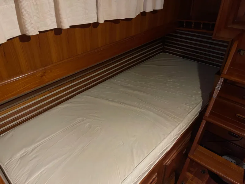 Slide: The Image of 1984 CHB 35 boat interior cabin with wooden bed and storage drawers - 13