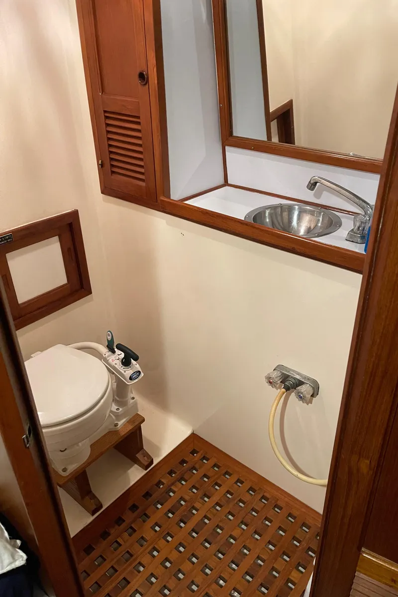 Slide: The Image of 1984 CHB 35 boat bathroom with wooden cabinetry and sink. - 14