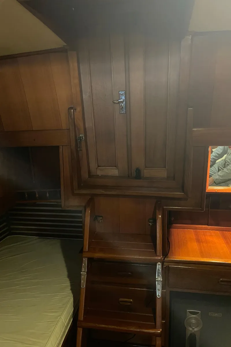 Slide: The Image of Interior of 1984 CHB 35 boat with wooden cabinetry and sleeping area. - 17