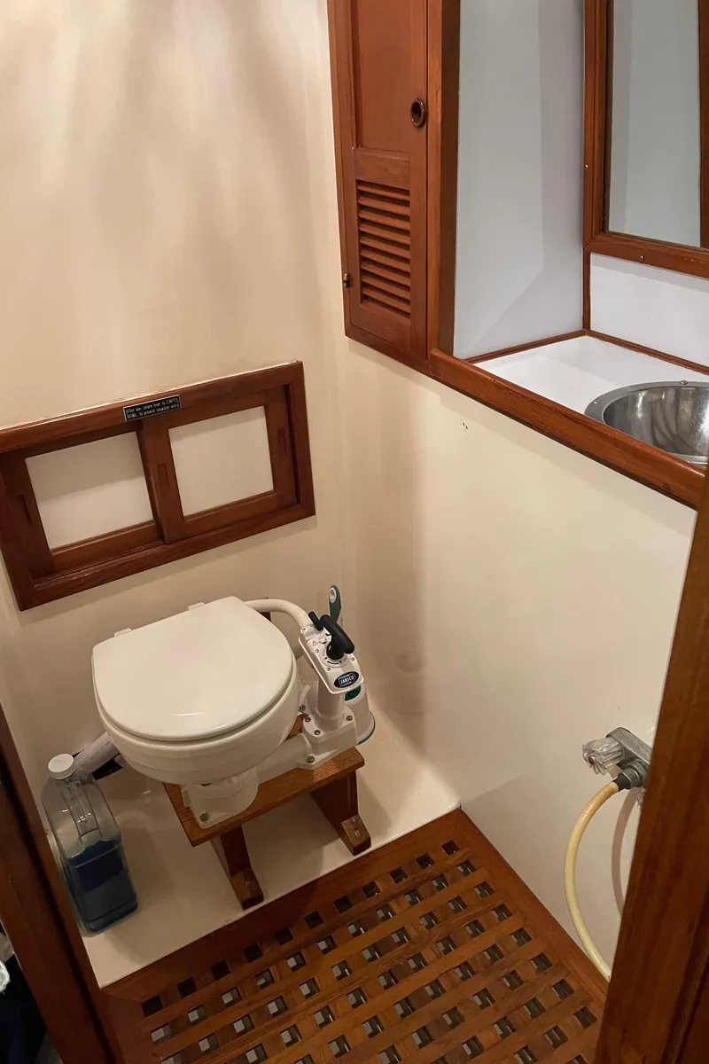 Slide: The Image of 1984 CHB 35 boat bathroom with wooden accents and marine toilet. - 18