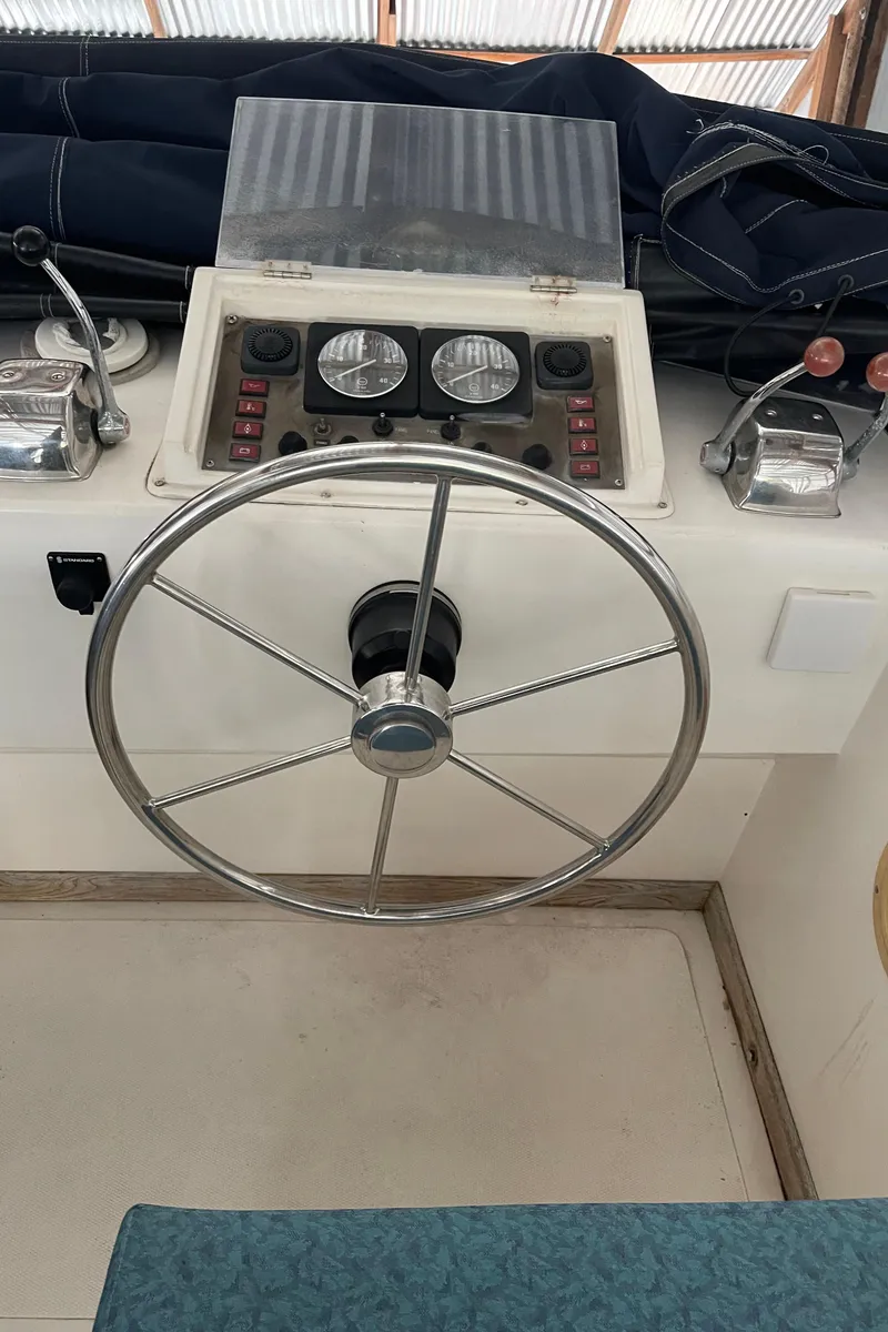 Slide: The Image of 1984 CHB 35 boat helm with steering wheel and control panel. - 26