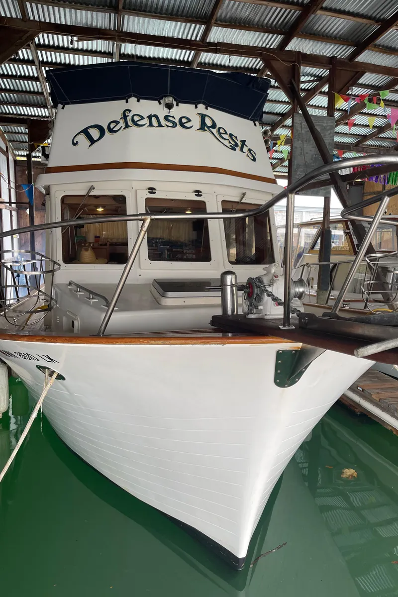 Slide: The Image of 1984 CHB 35 boat named Defense Rests docked in a covered marina. - 27