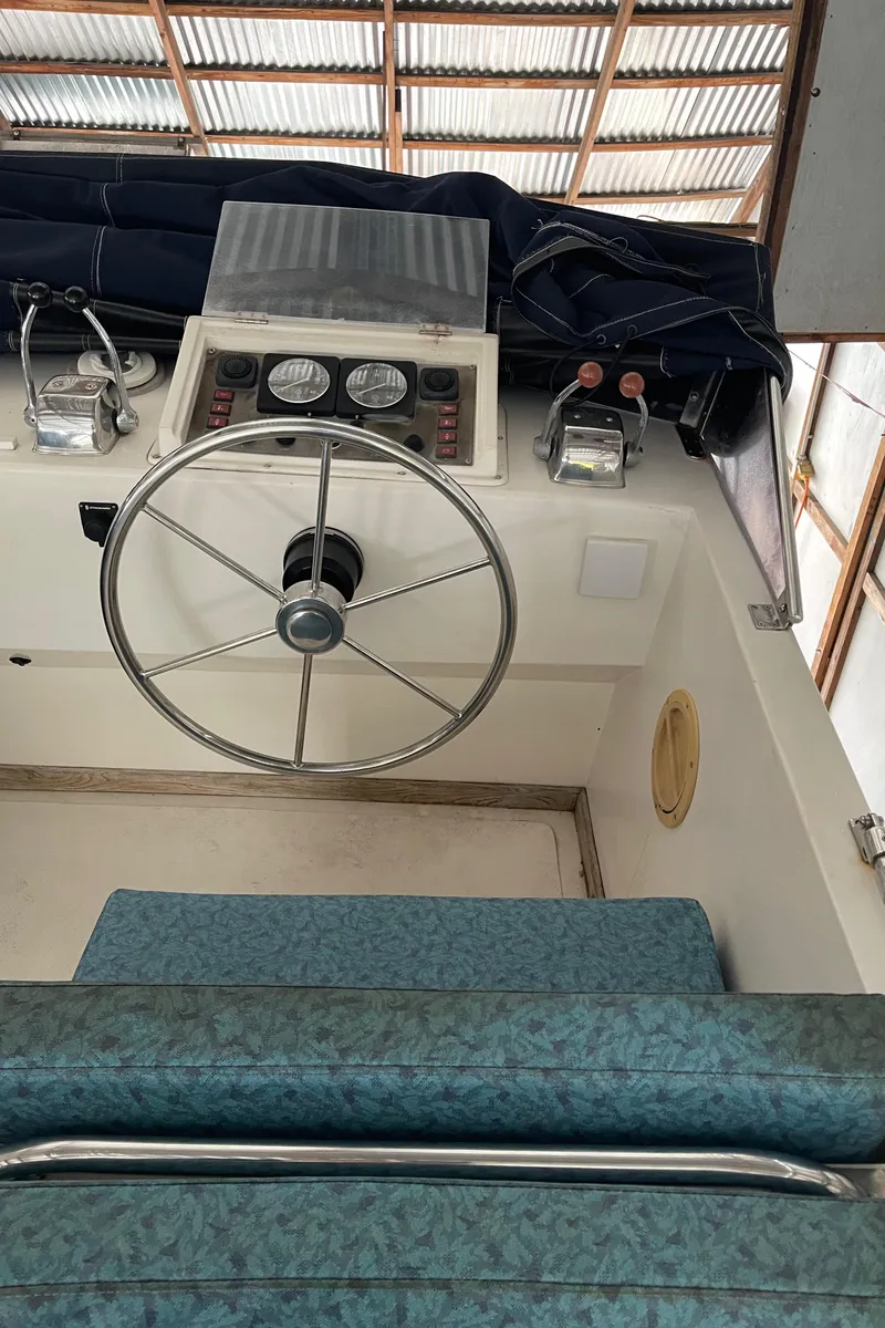 Slide: The Image of 1984 CHB 35 boat helm with steering wheel and instrument panel. - 29