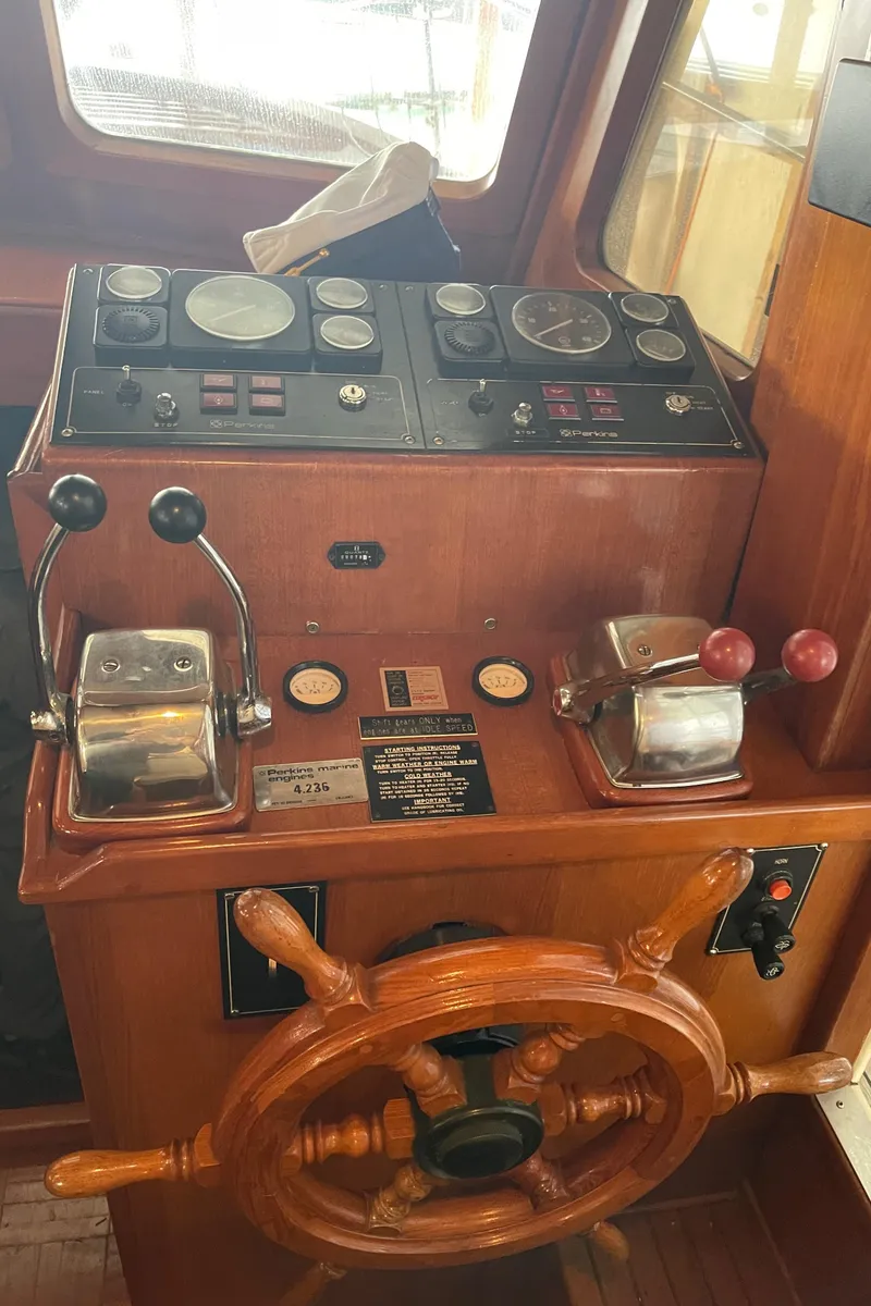 Slide: The Image of 1984 CHB 35 boat helm with wooden steering wheel and control panel. - 3