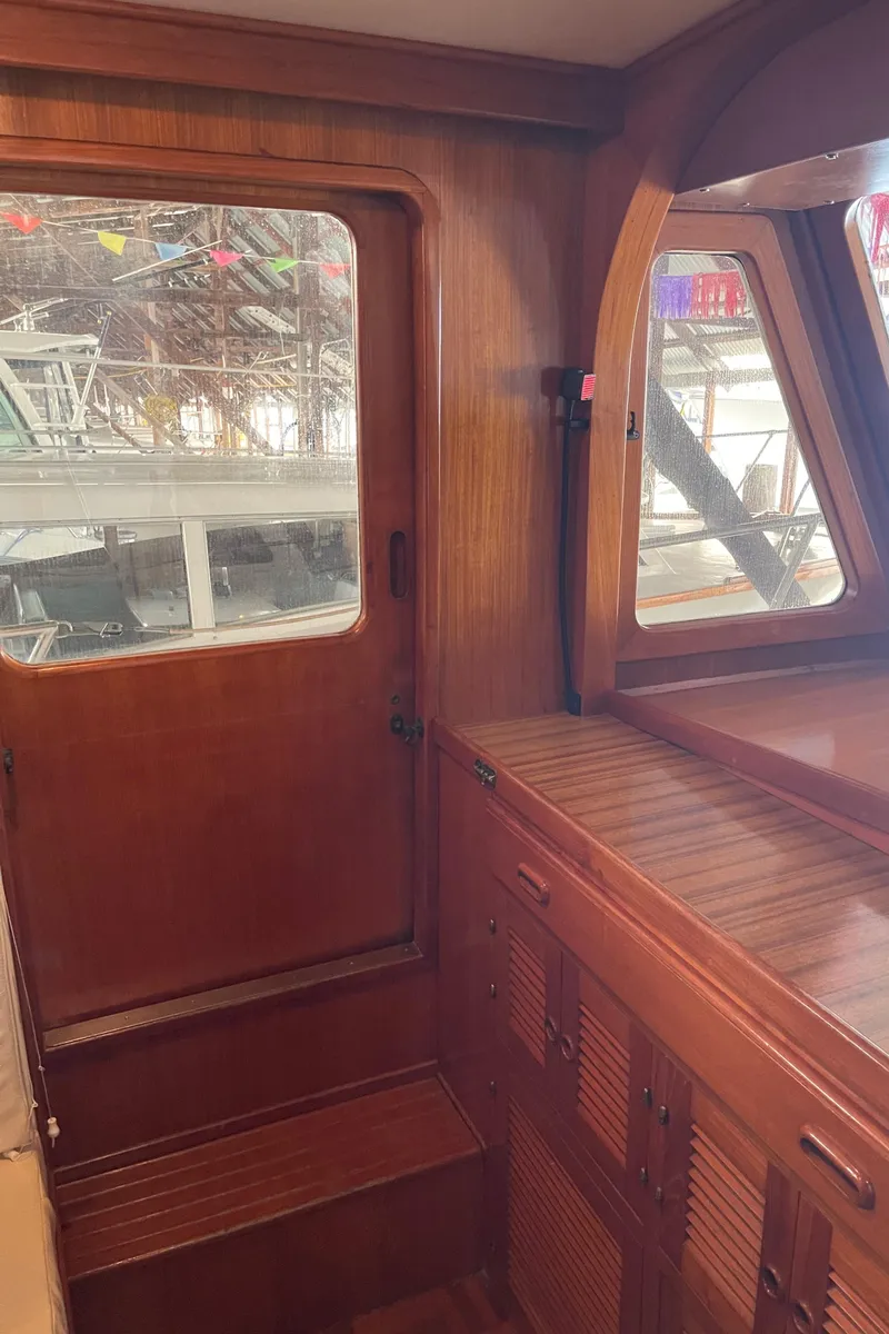 Slide: The Image of 1984 CHB 35 boat interior with wooden cabinetry and windows. - 31