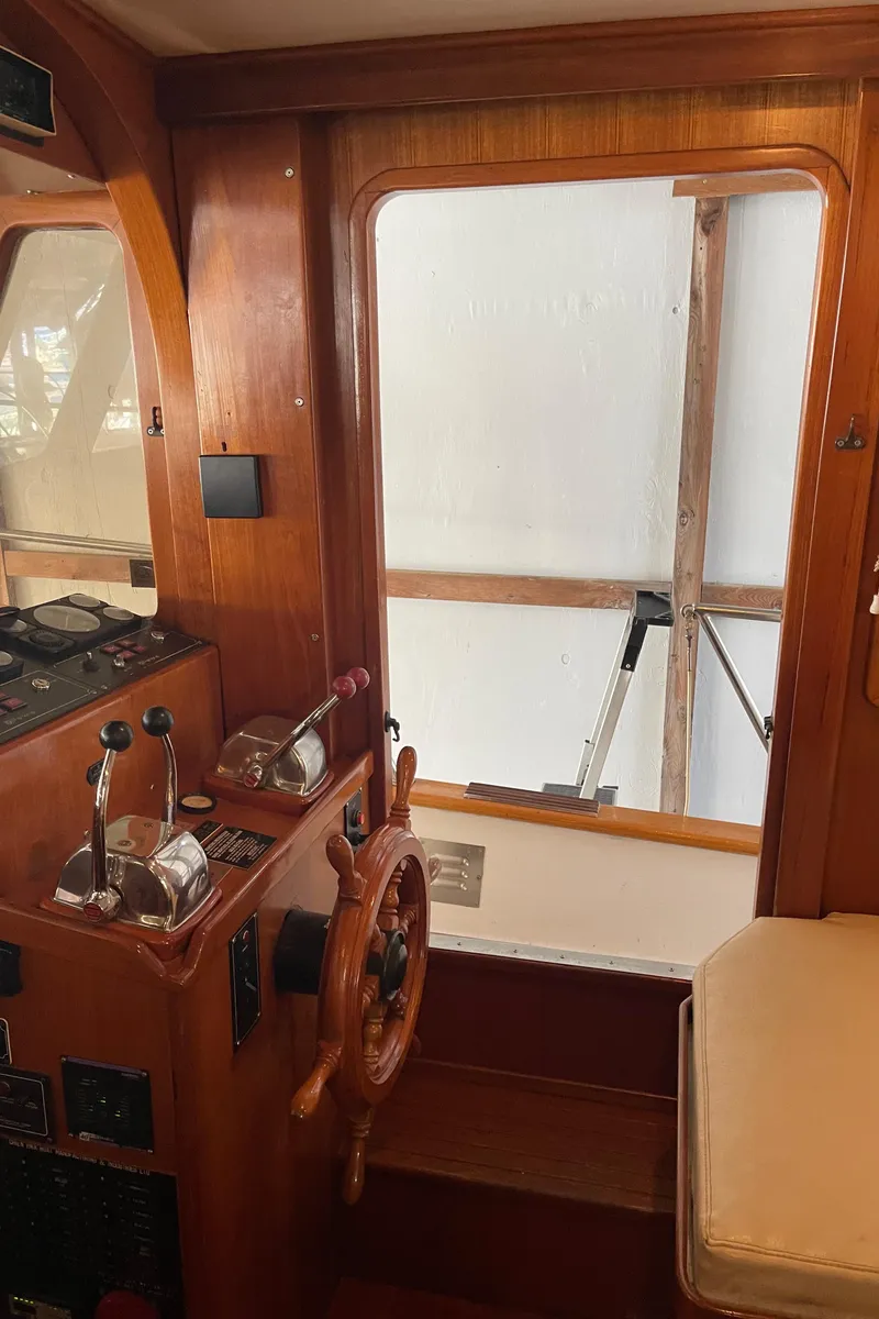Slide: The Image of Interior helm of 1984 CHB 35 boat with wooden steering wheel and controls. - 32