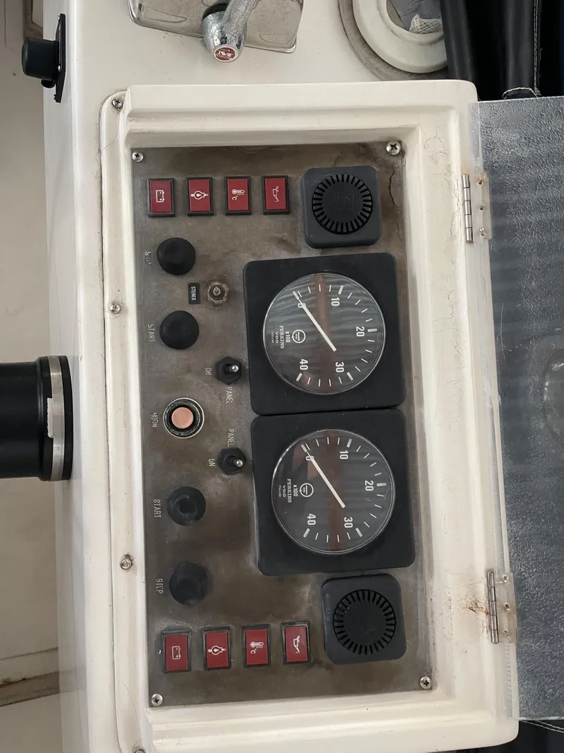 Slide: The Image of Control panel of a 1984 CHB 35 boat with gauges and switches. - 35