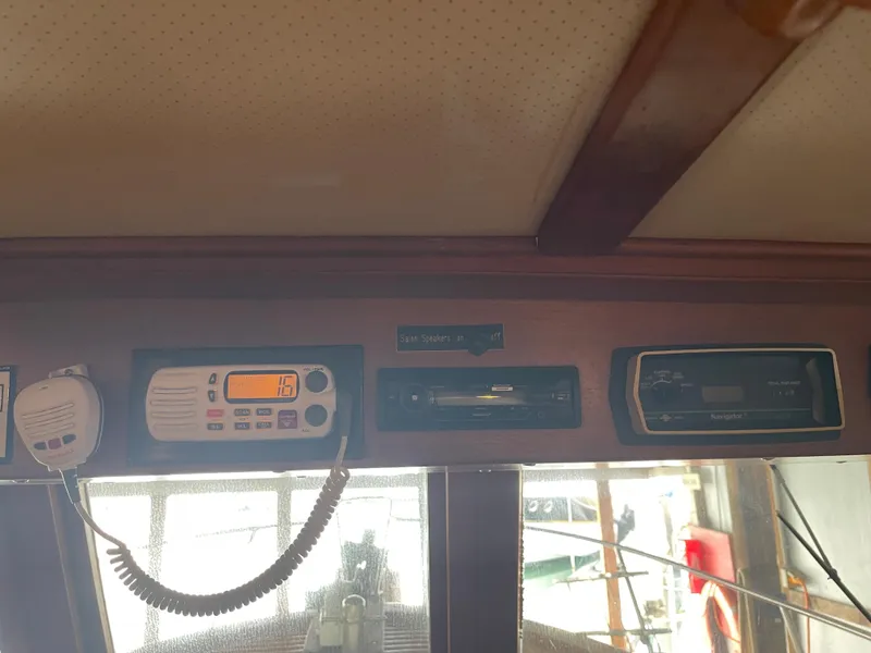 Slide: The Image of Control panel of a 1984 CHB 35 boat with radio and navigation equipment. - 37