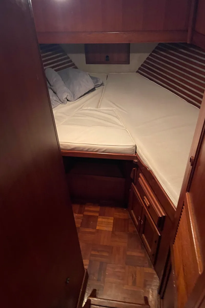 Slide: The Image of 1984 CHB 35 boat cabin with bed and wooden interior. - 6