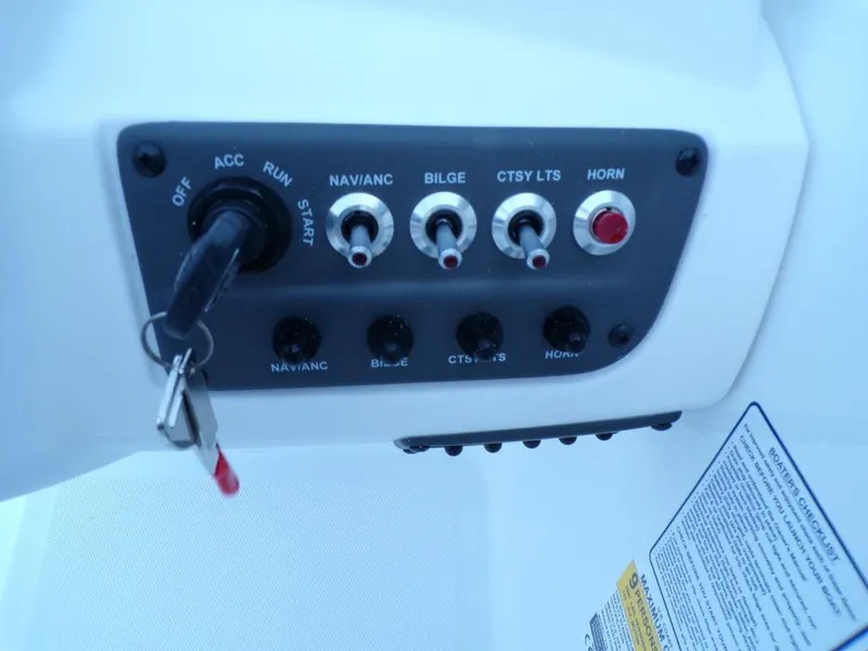Slide: The Image of Control panel of 2024 Tahoe T18 boat with ignition and switches. - 18