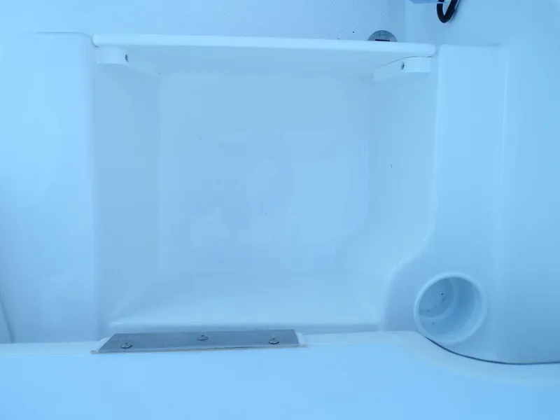 Slide: The Image of 2024 Tahoe T18 boat storage compartment with white interior. - 22