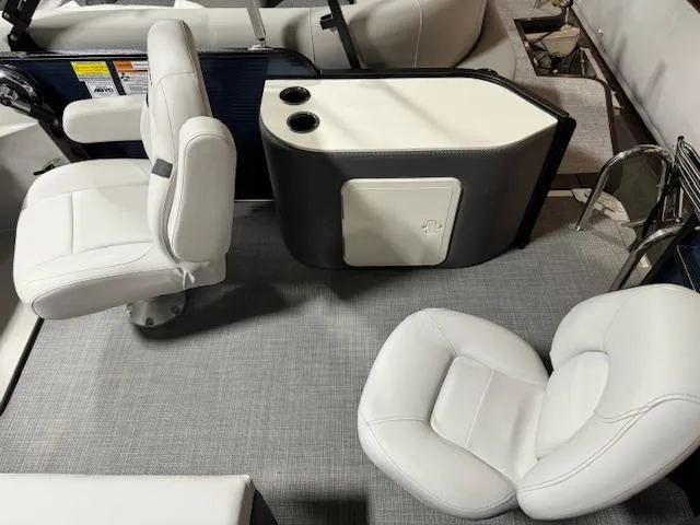 Slide: The Image of 2024 Crest Classic LX 200 C4 boat interior with white seating and cup holders. - 10