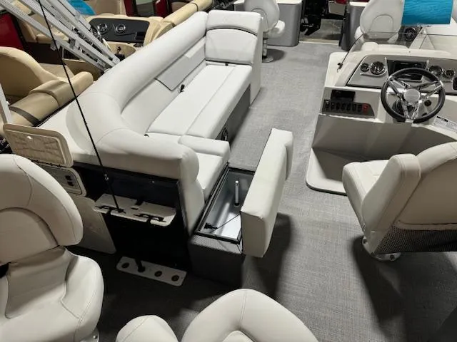 Slide: The Image of 2024 Crest Classic LX 200 C4 pontoon boat interior with white seating and modern controls. - 2